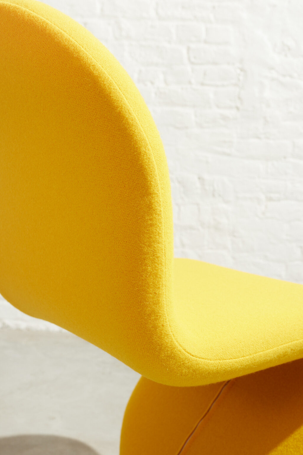 An original 1970s iconic cantilever Verner Panton 1-2-3 Series swivel dining chair with a brushed steel base. The chair is newly upholstered in a Kvadrat wool fabric.